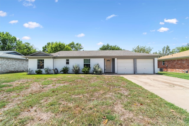 ranch-style house featuring a garage and a front yard