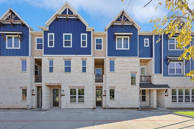 townhome / multi-family property with board and batten siding and stone siding