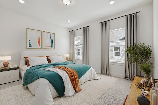 carpeted bedroom with recessed lighting, multiple windows, and baseboards