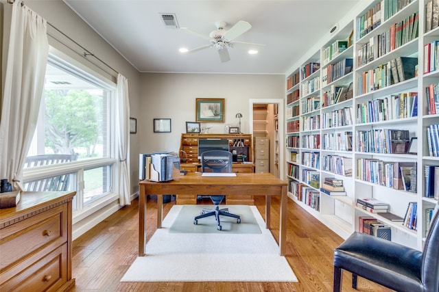 home office with ceiling fan and light hardwood / wood-style flooring