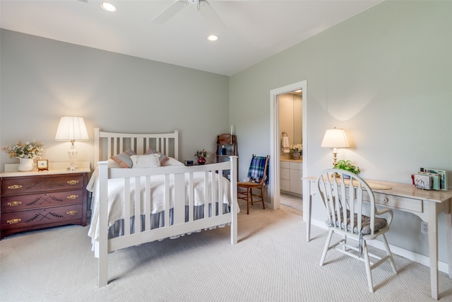 carpeted bedroom with ceiling fan and ensuite bath