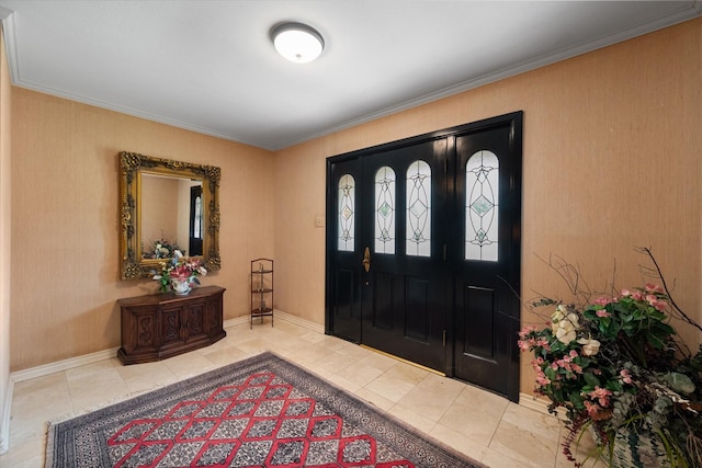 entrance foyer with tile patterned flooring and ornamental molding