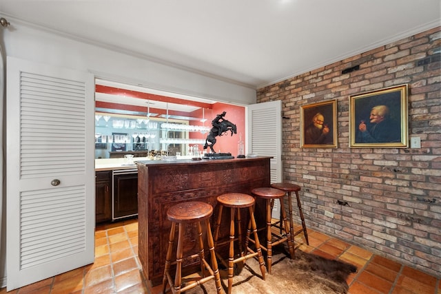 bar featuring dark brown cabinets, black dishwasher, hanging light fixtures, and brick wall