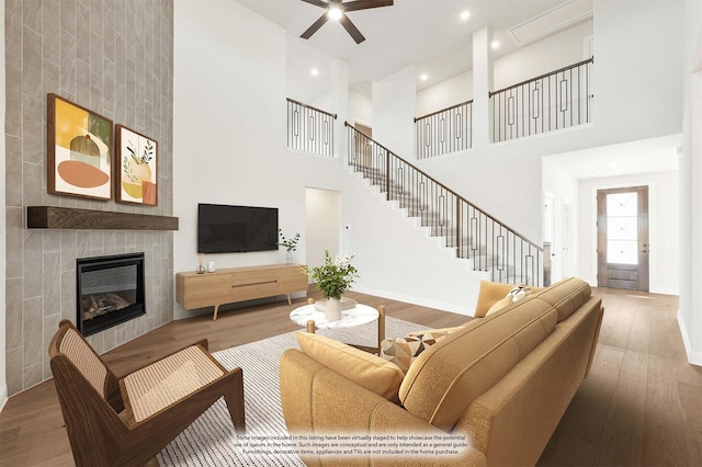 2302 Prosper Way, Mansfield, TX 76063 - living area featuring stairs, a fireplace, wood finished floors, and a ceiling fan