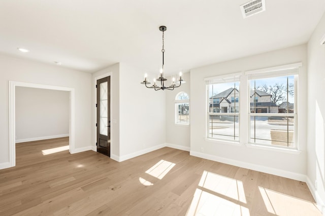 2302 Prosper Way, Mansfield, TX 76063 - unfurnished dining area featuring an inviting chandelier, a wealth of natural light, light wood finished floors, and visible vents