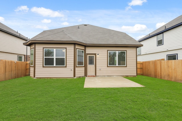 rear view of house with a patio area and a lawn