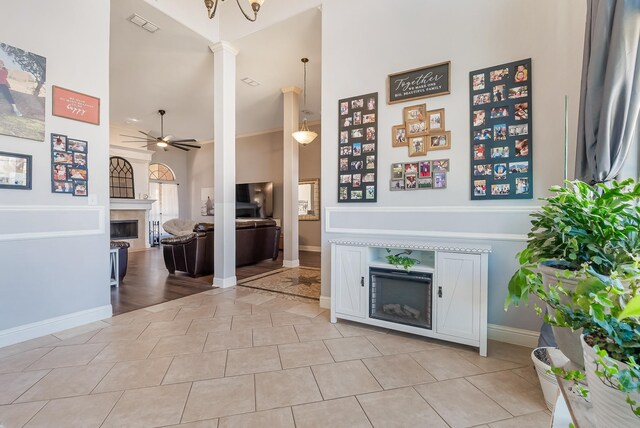 kitchen with sink, stainless steel refrigerator with ice dispenser, light stone countertops, black dishwasher, and white cabinetry