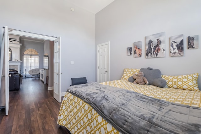 bedroom featuring dark wood-type flooring and a fireplace