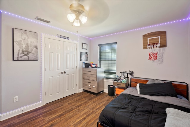 bedroom featuring ceiling fan, dark hardwood / wood-style flooring, and a closet