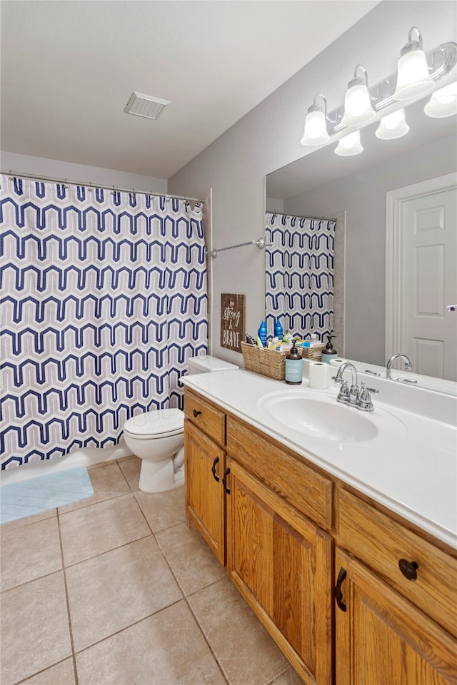 bathroom with tile patterned flooring, vanity, and toilet