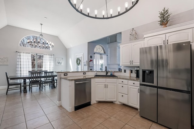 kitchen featuring sink, stainless steel appliances, light stone counters, white cabinets, and light tile patterned flooring