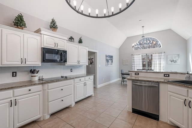 kitchen with white cabinetry, vaulted ceiling, black appliances, and tasteful backsplash