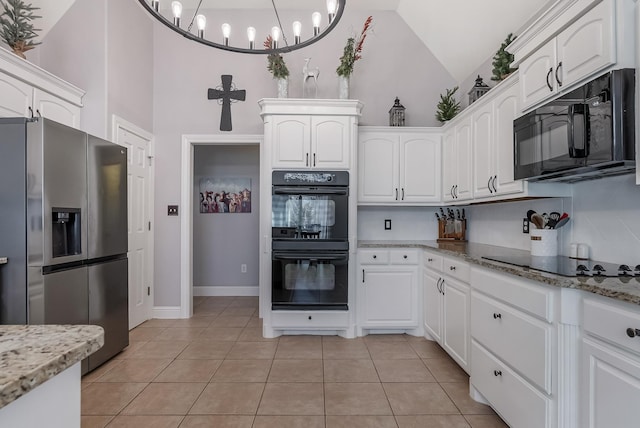 kitchen featuring white cabinetry, light stone countertops, black appliances, and light tile patterned flooring