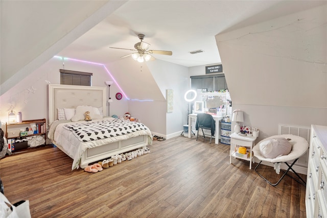 bedroom with ceiling fan, wood-type flooring, and vaulted ceiling