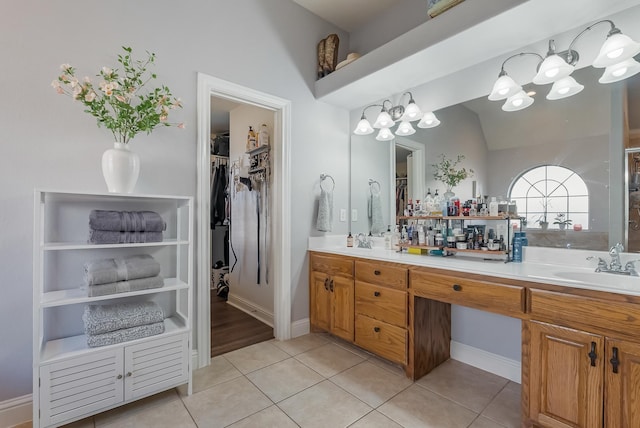 bathroom featuring vanity, tile patterned flooring, and vaulted ceiling