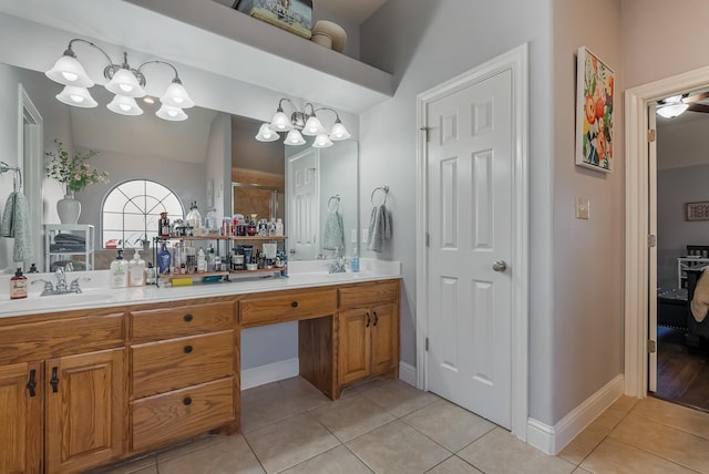 bathroom with tile patterned flooring, vanity, and a chandelier