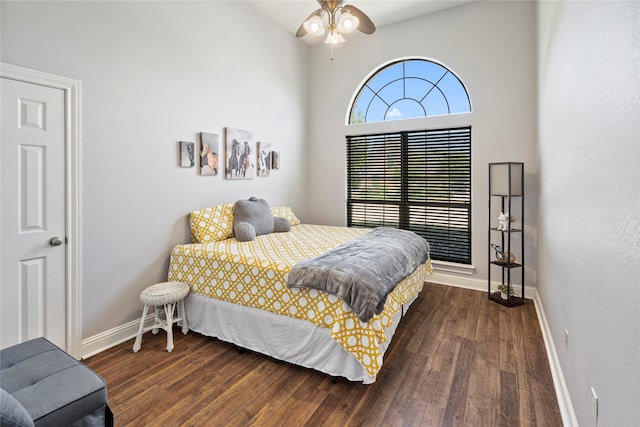 bedroom with ceiling fan and dark hardwood / wood-style floors