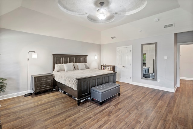 bedroom featuring a tray ceiling, ceiling fan, and dark hardwood / wood-style floors