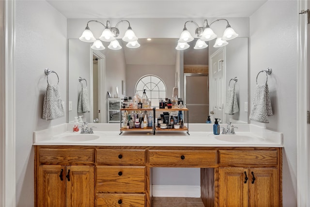 bathroom with tile patterned flooring, vanity, and walk in shower