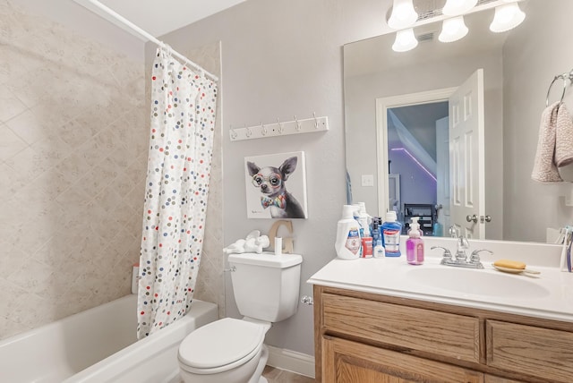 full bathroom with vanity, shower / bath combo with shower curtain, and toilet