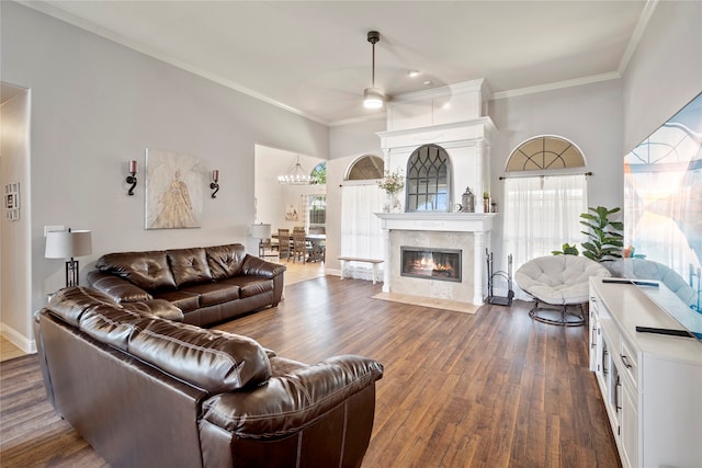 living room with dark hardwood / wood-style floors, ceiling fan, and crown molding