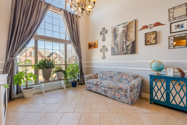 sitting room with a healthy amount of sunlight, a chandelier, and light tile patterned floors