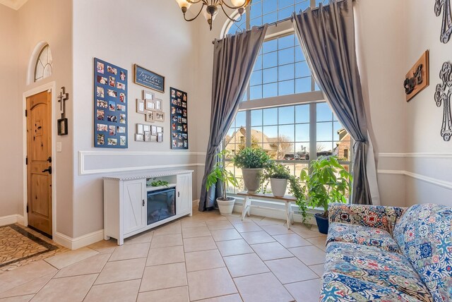 kitchen featuring light tile patterned flooring, backsplash, white cabinetry, and black appliances