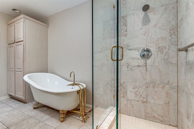 bathroom with shower with separate bathtub and tile patterned floors