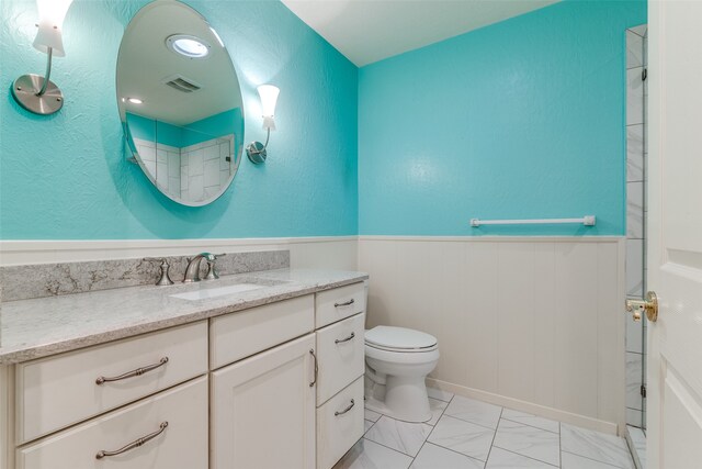 bathroom featuring tile patterned floors, vanity, and toilet