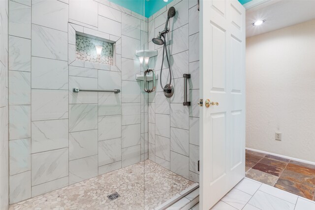 bathroom with tile patterned flooring and a tile shower