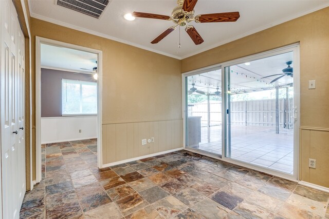 empty room featuring tile patterned floors, ornamental molding, and ceiling fan