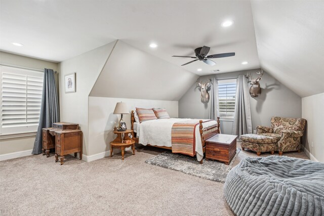 carpeted bedroom with ceiling fan and vaulted ceiling