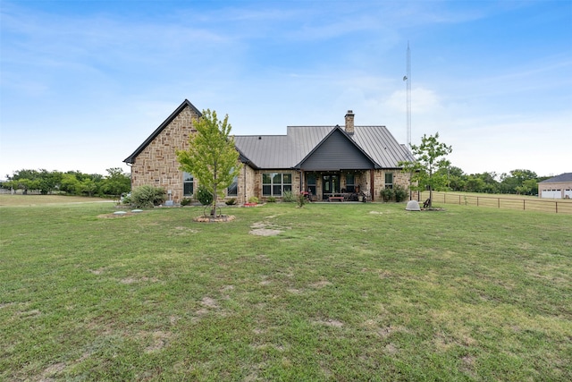 rear view of house with a yard