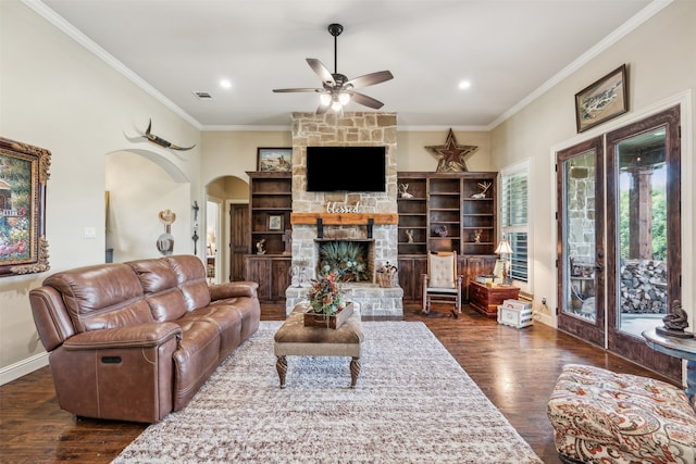 living room featuring a stone fireplace, crown molding, and dark wood-type flooring