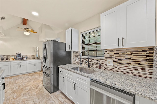 kitchen with vaulted ceiling with beams, stainless steel appliances, sink, and white cabinets