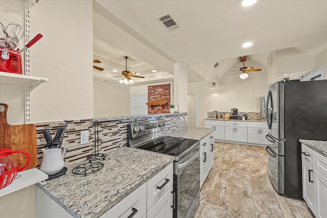 kitchen with tasteful backsplash, appliances with stainless steel finishes, light stone countertops, and white cabinets