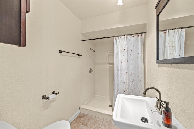 bathroom with sink, a shower with curtain, tile patterned floors, and toilet