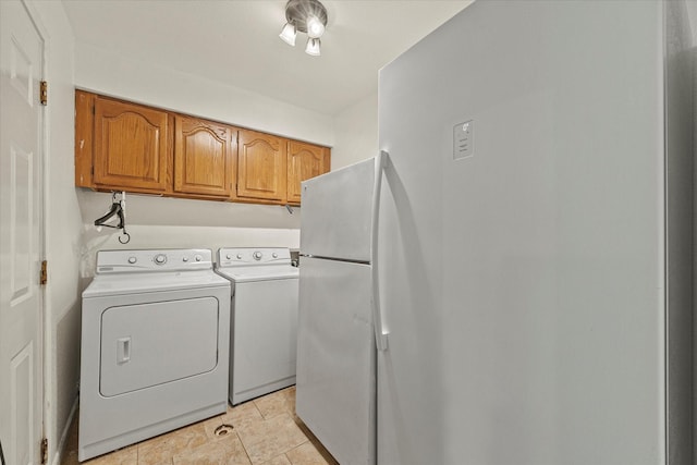 laundry area featuring separate washer and dryer and cabinets