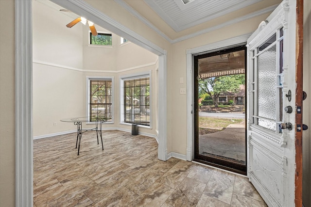 entrance foyer with crown molding, a wealth of natural light, and ceiling fan