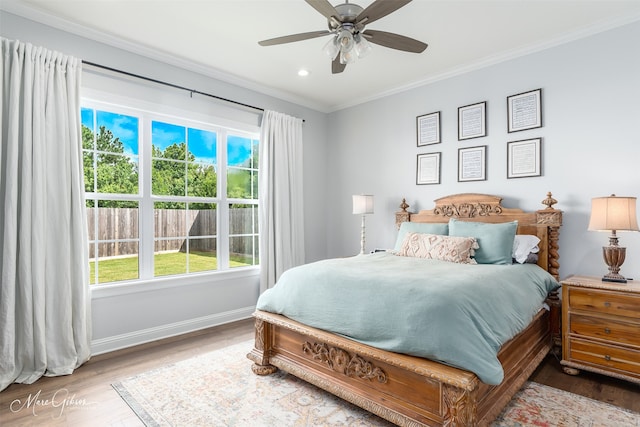 bedroom featuring ceiling fan, wood-type flooring, and crown molding