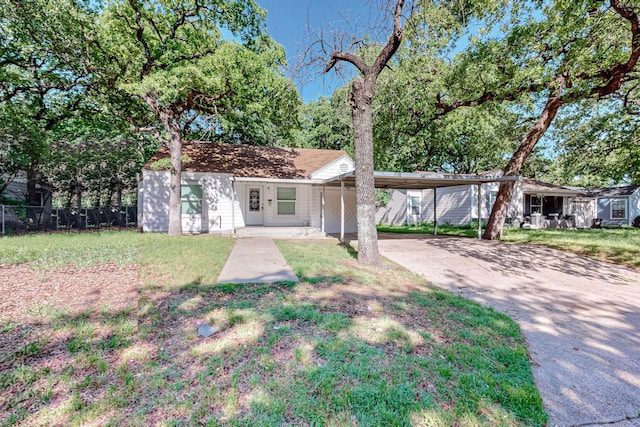 ranch-style home featuring a carport and a front yard