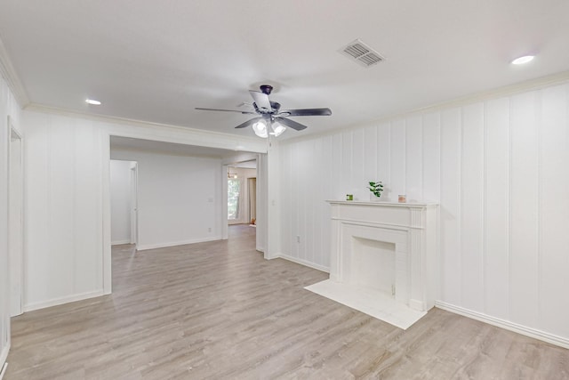 unfurnished living room with crown molding, light wood-type flooring, and ceiling fan