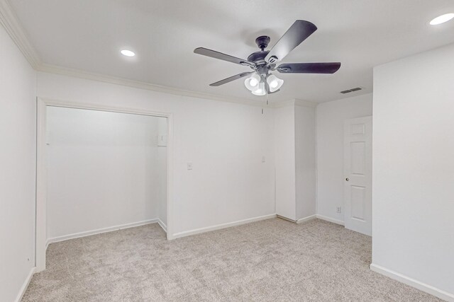 carpeted empty room featuring ornamental molding and ceiling fan