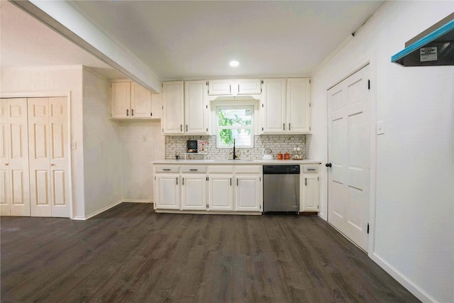 kitchen with white cabinetry, stainless steel dishwasher, dark hardwood / wood-style floors, decorative backsplash, and sink