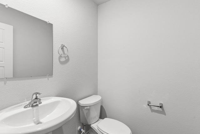 bathroom featuring toilet and sink