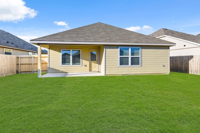 back of property with a patio area and a lawn