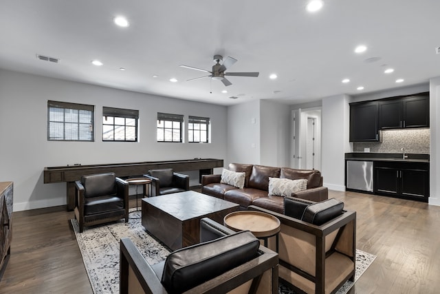 living room with sink, ceiling fan, and hardwood / wood-style floors