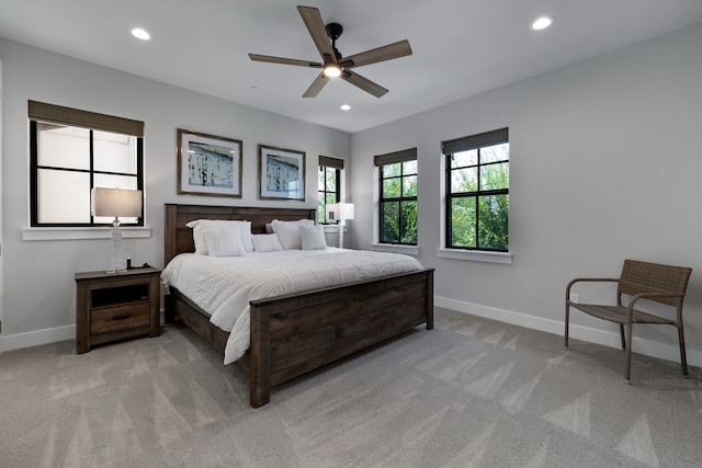 bedroom featuring light carpet and ceiling fan