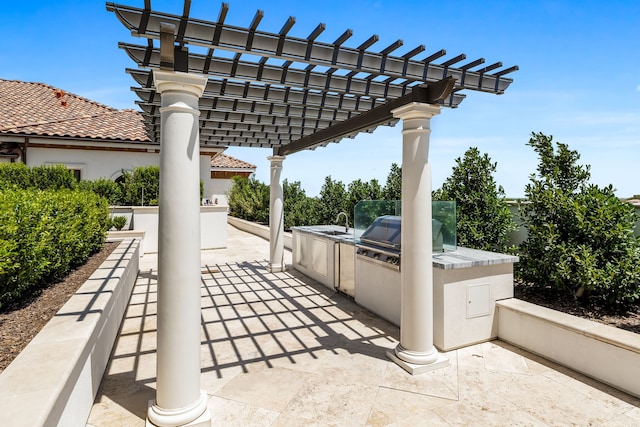 view of patio featuring area for grilling and a pergola