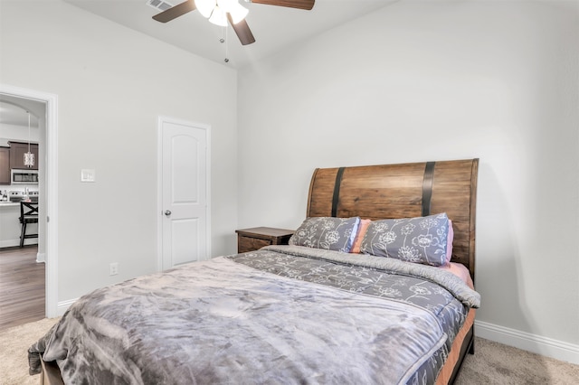 bedroom featuring lofted ceiling, carpet, and ceiling fan